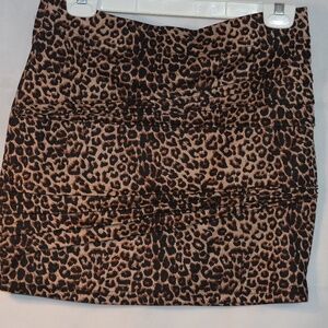 Lepoard It has small pleats in the body of Miniskirt.  Stretch SZ 12 Qed London